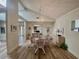 Bright dining room with glass-top table and four chairs, hardwood floors and chandelier at 120 Oakmont Ln, New Smyrna Beach, FL 32168