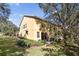 Townhouse with a patio, grassy backyard, and mature trees at 2681 Sweet Magnolia Pl, Oviedo, FL 32765