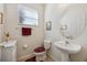 Clean and modern bathroom with pedestal sink and toilet at 2681 Sweet Magnolia Pl, Oviedo, FL 32765