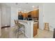 Well-equipped kitchen with dark wood cabinets, black appliances, and a breakfast bar at 2681 Sweet Magnolia Pl, Oviedo, FL 32765