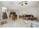 Open living room with a view of the kitchen and staircase at 2681 Sweet Magnolia Pl, Oviedo, FL 32765