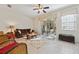 Living room with a ceiling fan, comfortable seating, and access to a patio at 2681 Sweet Magnolia Pl, Oviedo, FL 32765