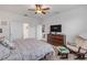 Main bedroom with king bed, dresser, and rocking chair at 2820 Neverland Dr, New Smyrna Beach, FL 32168