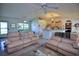 Spacious living room with two sofas and a view of the kitchen at 3218 Royal Palm Dr, Edgewater, FL 32141