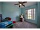 Bright bedroom with ceiling fan and window at 3218 Royal Palm Dr, Edgewater, FL 32141