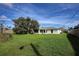 Large backyard with grassy lawn and mature tree at 3218 Royal Palm Dr, Edgewater, FL 32141