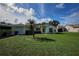 Single story house with attached garage, green lawn and palm tree at 3218 Royal Palm Dr, Edgewater, FL 32141