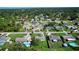 Aerial view of a residential area featuring houses, streets, and lush greenery at 3218 Royal Palm Dr, Edgewater, FL 32141