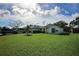 Single-story house with a green lawn, driveway, and a palm tree in the front yard at 3218 Royal Palm Dr, Edgewater, FL 32141