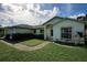 House exterior showcasing a well-maintained lawn and landscaping at 3218 Royal Palm Dr, Edgewater, FL 32141
