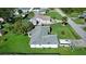Single-story house, gray roof, large backyard, and a school bus parked nearby at 3218 Royal Palm Dr, Edgewater, FL 32141