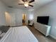 Bedroom with king bed, ceiling fan, and en-suite bathroom at 3325 Pintello Ave, New Smyrna Beach, FL 32168