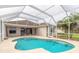 Screened pool and patio area with lake view at 3385 Tesoro Cir, New Smyrna Beach, FL 32168