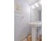 Clean and classic pedestal sink bathroom with light-blue walls at 4017 Saxon Dr, New Smyrna Beach, FL 32169