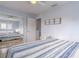 Bedroom with mirrored closet doors and striped bedding at 4017 Saxon Dr, New Smyrna Beach, FL 32169