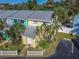 Brightly colored two-story townhome with a white picket fence and tropical landscaping at 4017 Saxon Dr, New Smyrna Beach, FL 32169