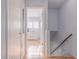 Well-lit hallway with light-blue walls and wood floors at 4017 Saxon Dr, New Smyrna Beach, FL 32169