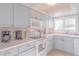 Well-equipped kitchen with light blue cabinets and white appliances at 4017 Saxon Dr, New Smyrna Beach, FL 32169