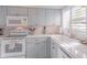 Clean and bright kitchen, featuring white appliances and light blue cabinets at 4017 Saxon Dr, New Smyrna Beach, FL 32169