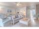 Bright and airy living room with coastal decor and comfy wicker furniture at 4017 Saxon Dr, New Smyrna Beach, FL 32169