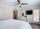 Main bedroom with a dresser, TV and access to balcony at 4155 S Atlantic Ave # 1030, New Smyrna Beach, FL 32169