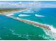 Long jetty extending into ocean with waves crashing at 4590 S Atlantic Ave # 263, Ponce Inlet, FL 32127