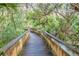 Wooden boardwalk path through lush vegetation at 4590 S Atlantic Ave # 263, Ponce Inlet, FL 32127