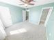 Comfortable bedroom with ceiling fan and access to a bathroom at 4590 S Atlantic Ave # 263, Ponce Inlet, FL 32127