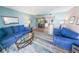 Open living area with two sofas and access to balcony at 4590 S Atlantic Ave # 263, Ponce Inlet, FL 32127