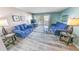 Living room with blue sofas and a view to the balcony at 4590 S Atlantic Ave # 263, Ponce Inlet, FL 32127