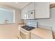 White kitchen features a cooktop, microwave, and ample counter space at 5201 S Atlantic Ave # 809A, New Smyrna Beach, FL 32169