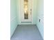 Inviting front entrance with a light-colored door and tiled flooring at 555 Coronado Cove Rd, New Smyrna Beach, FL 32168