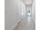 Bright hallway with tile floors and two storage closets at 555 Coronado Cove Rd, New Smyrna Beach, FL 32168