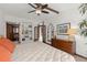Main bedroom with large mirror, dresser, and ceiling fan at 624 S Pine St, New Smyrna Beach, FL 32169