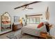 Main bedroom with a ceiling fan and mid-century modern furniture at 624 S Pine St, New Smyrna Beach, FL 32169