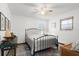 Cozy bedroom with a metal bed frame and a ceiling fan at 624 S Pine St, New Smyrna Beach, FL 32169