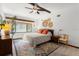 Main bedroom with a ceiling fan, wood dresser, and area rug at 624 S Pine St, New Smyrna Beach, FL 32169