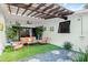 Covered patio with seating, artificial turf and pergola at 624 S Pine St, New Smyrna Beach, FL 32169