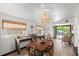 Bright dining room with wooden table, access to backyard, and unique light fixture at 624 S Pine St, New Smyrna Beach, FL 32169