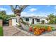 Cute mid-century home with unique landscaping and a brick driveway at 624 S Pine St, New Smyrna Beach, FL 32169