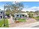 Attractive light blue home with landscaped yard and paver driveway at 624 S Pine St, New Smyrna Beach, FL 32169