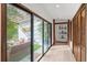 Light-filled hallway with access to a private courtyard and built-in shelving at 624 S Pine St, New Smyrna Beach, FL 32169