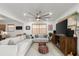 Open living room showcasing a sectional sofa and large TV at 624 S Pine St, New Smyrna Beach, FL 32169