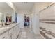 Main bathroom with double vanity and walk-in closet access at 639 Lazio Cir, Debary, FL 32713