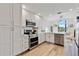 Modern kitchen with white cabinets, stainless steel appliances, and quartz countertops at 663 Wellesley Ct, New Smyrna Beach, FL 32168