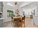 Open concept kitchen and dining area with stainless steel appliances and white cabinets at 663 Wellesley Ct, New Smyrna Beach, FL 32168