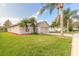 Attractive single-story house with a well-manicured lawn and palm trees at 6793 Calistoga Cir, Port Orange, FL 32128