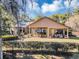 Home's backyard with covered patio, seating area, and lush landscaping at 1032 Early Ave, Winter Park, FL 32789