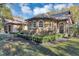 Stone and stucco home with manicured hedges at 1032 Early Ave, Winter Park, FL 32789