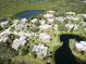 Aerial view showcasing property location within a tranquil waterfront community at 114 Cedar Dunes Dr, New Smyrna Beach, FL 32169